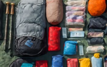 Lightweight backpacking tent beside a loaded pack on a forest trail
