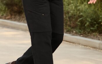 Woman wearing adaptable hiking layers on a mountain trail