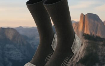 Man wearing a breathable summer hiking outfit with socks and walking poles