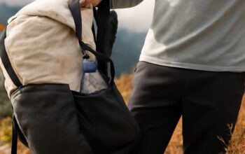Super-ultralight backpacking kit beside a fitted women's pack on a forest trail