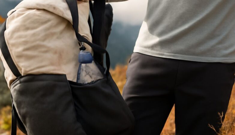 Super-ultralight backpacking kit beside a fitted women's pack on a forest trail
