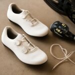 A pair of women's cycling shoes on a wooden floor