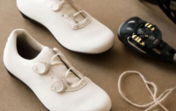 A pair of women's cycling shoes on a wooden floor
