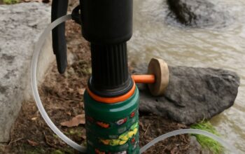 A portable water filter used in a hiking setting